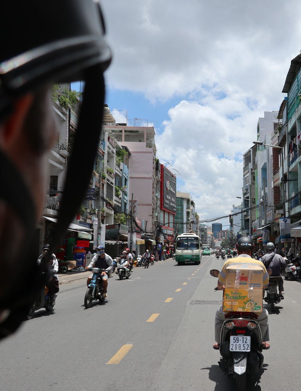 Man on scooter, driving through foreign city