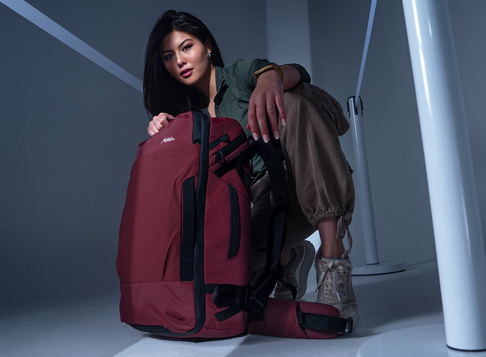 woman in studio setting, crouching down to garnet Globerider35