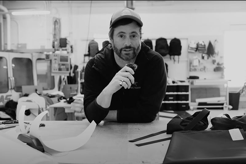 Man at workbench, holding microphone