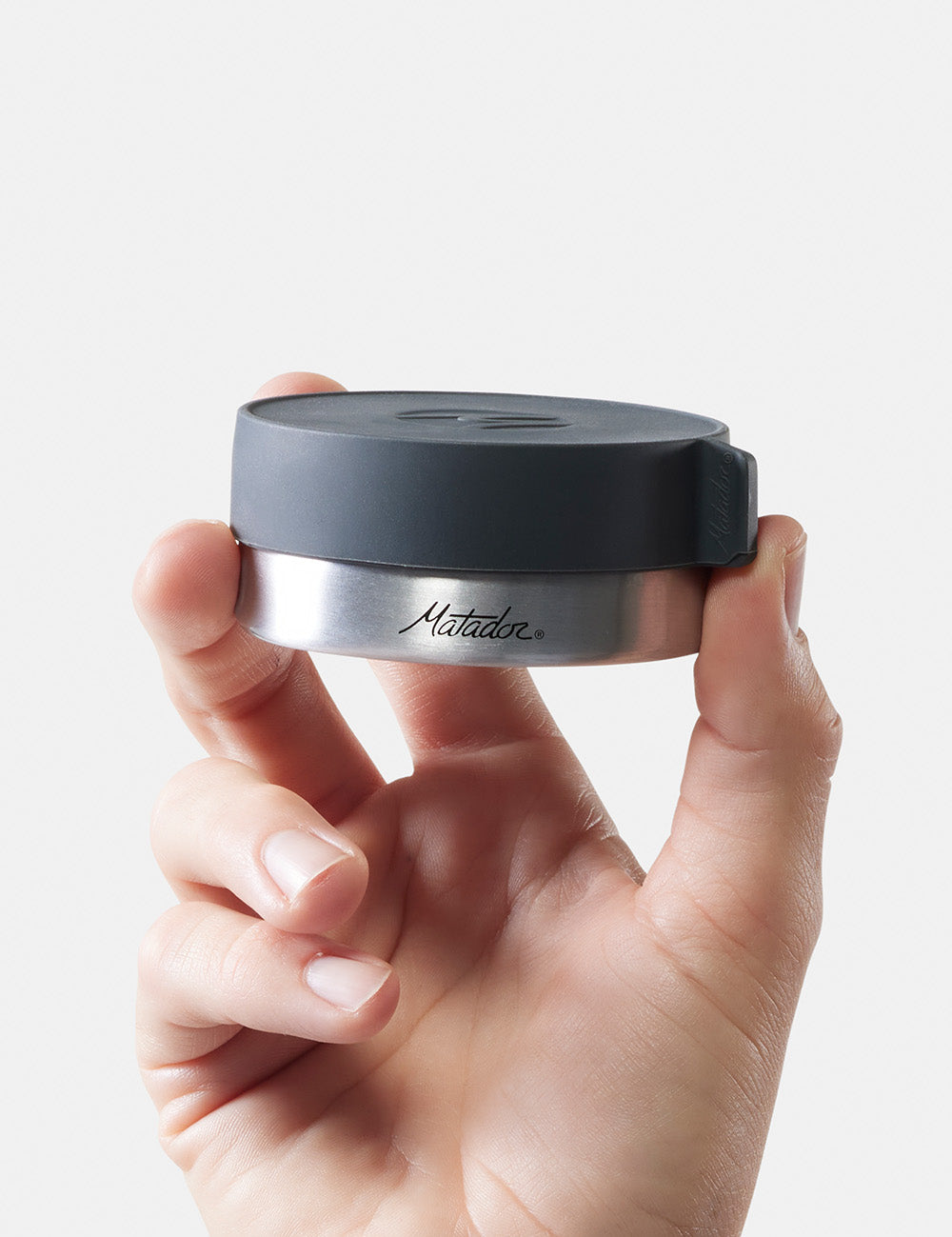 hand holding up 100ml waterproof canister