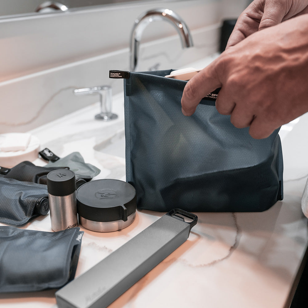 hands placing toiletries on bathroom counter