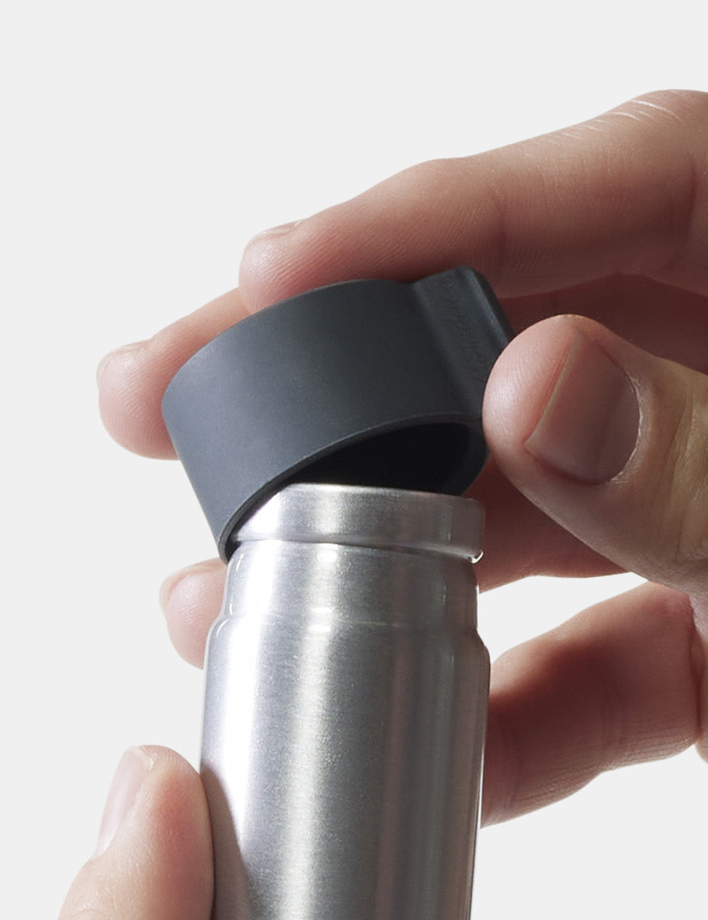 hands removing lid of small canister