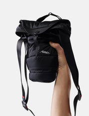 Black camera base layer held by a hand on a light gray background