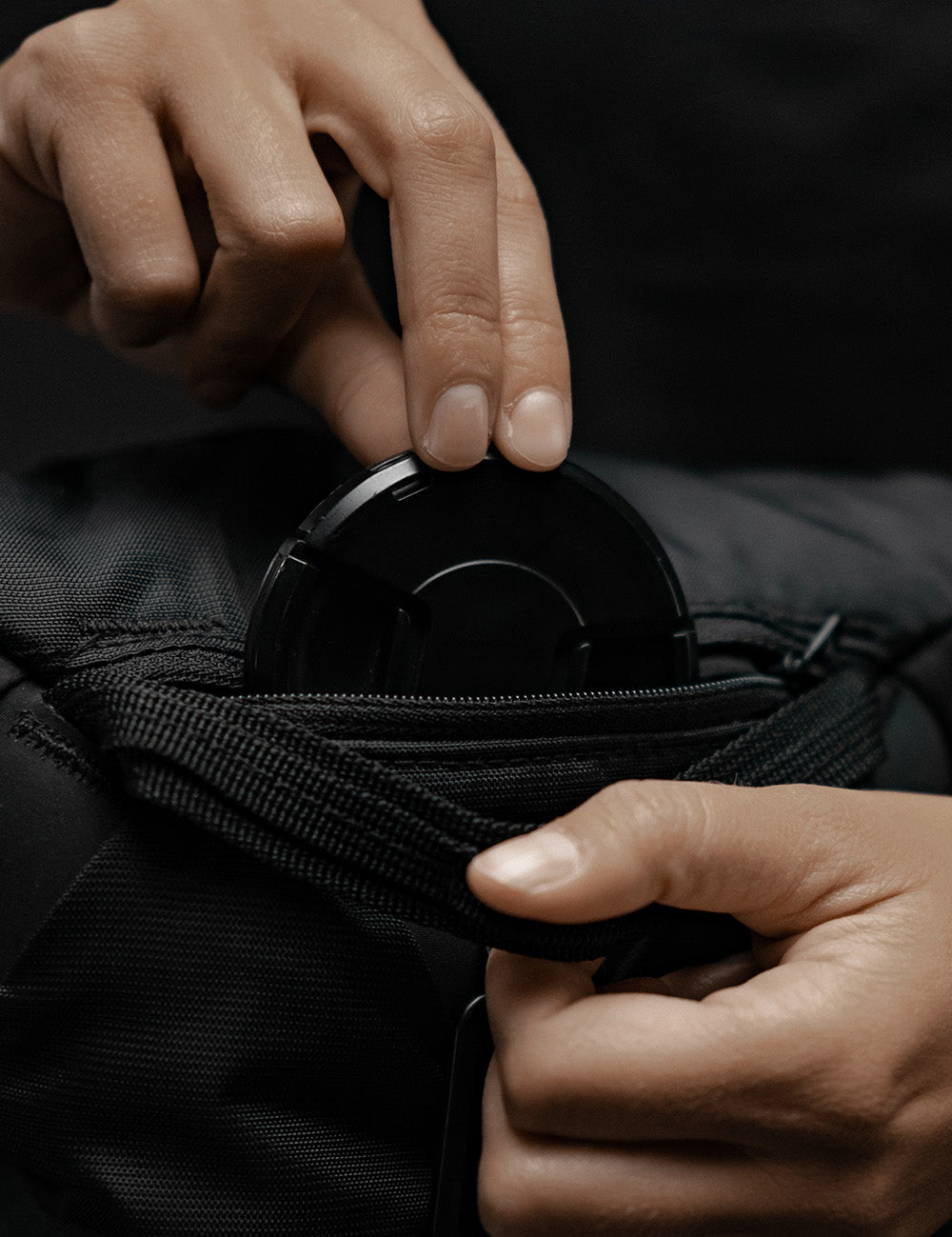 placing lens
 cap in small zipper pocket