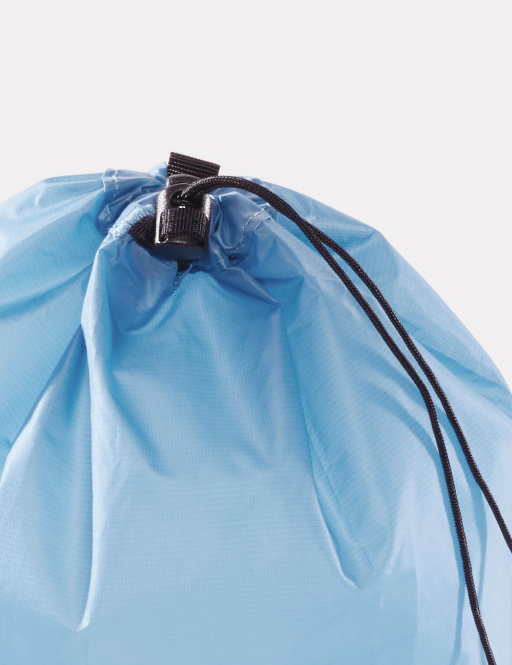 close up view of drawstring closure on blue bag