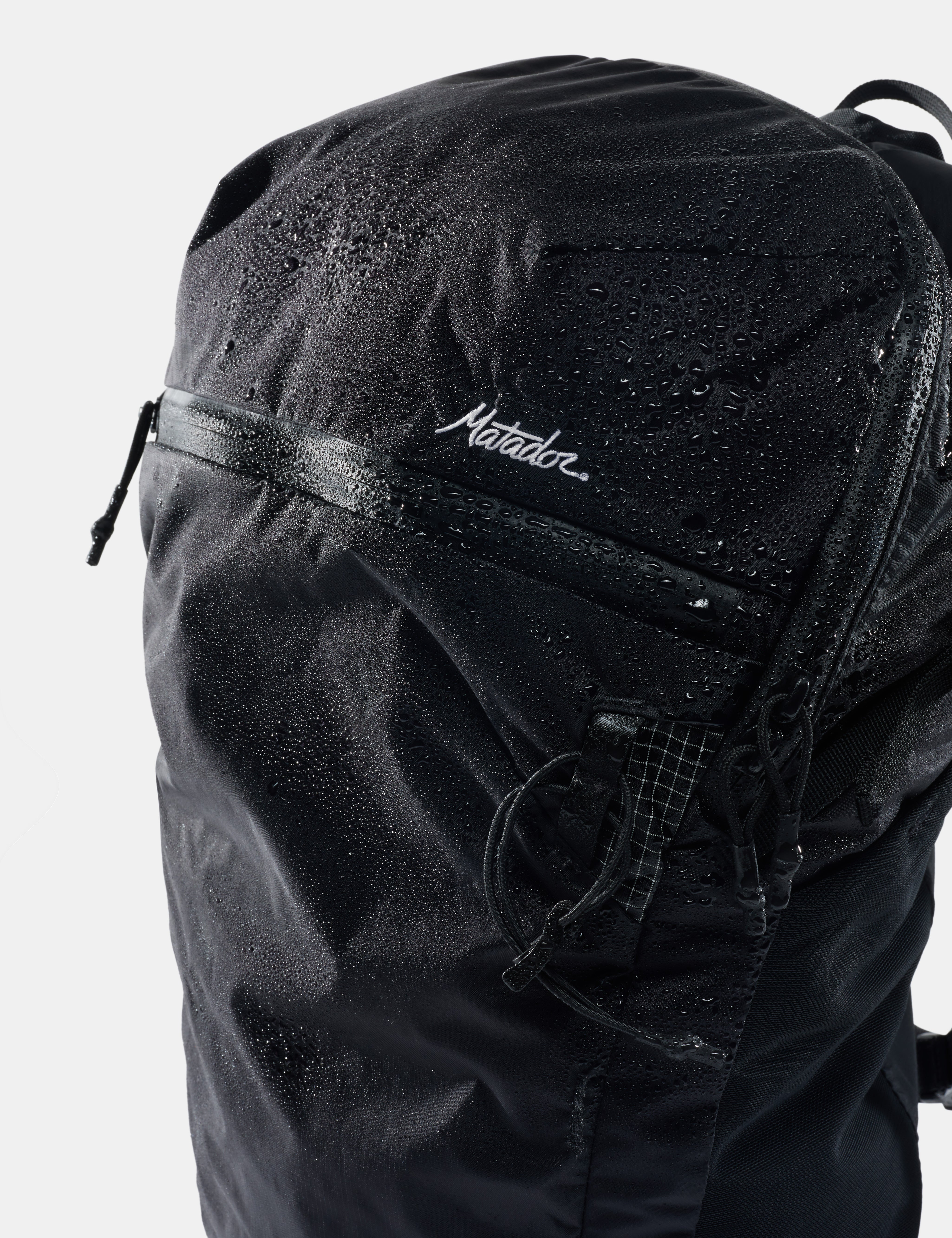Black backpack with 'matdor' branding on a light gray background
