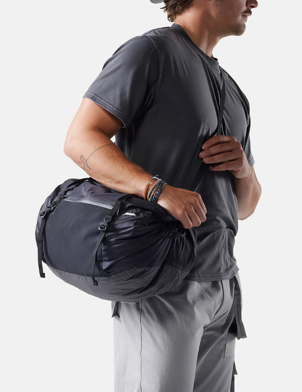 man wearing duffle across his body