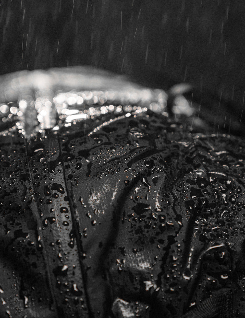 close up view of water beading on black fabric