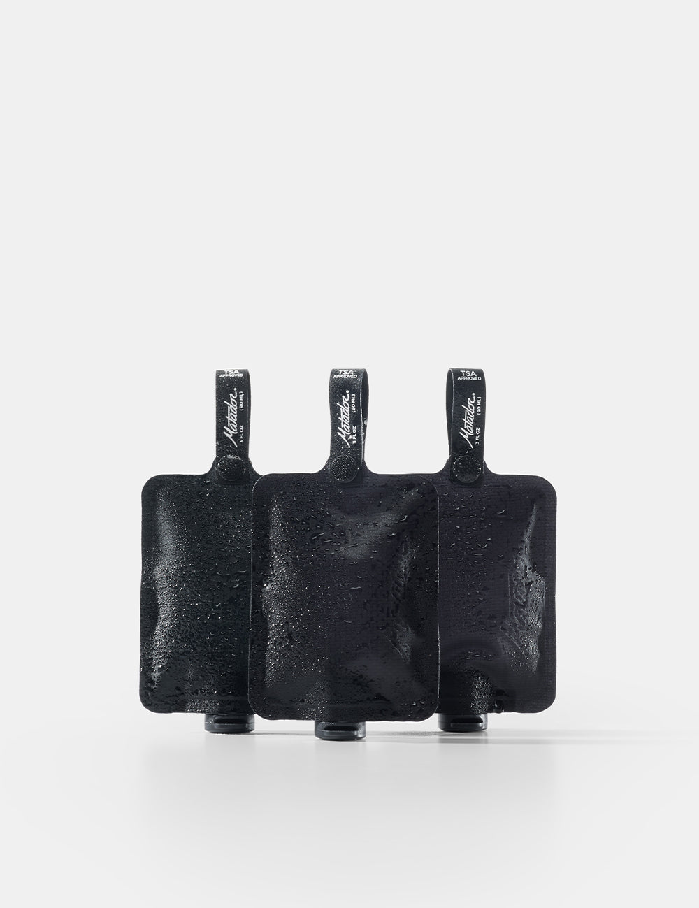 Three black toiletry bottles on a white background