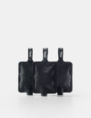 Three black toiletry bottles on a white background