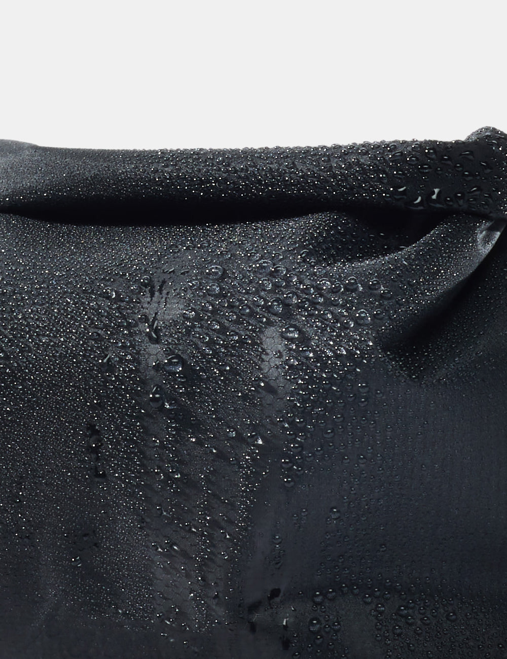 close up view of water beading on black fabric