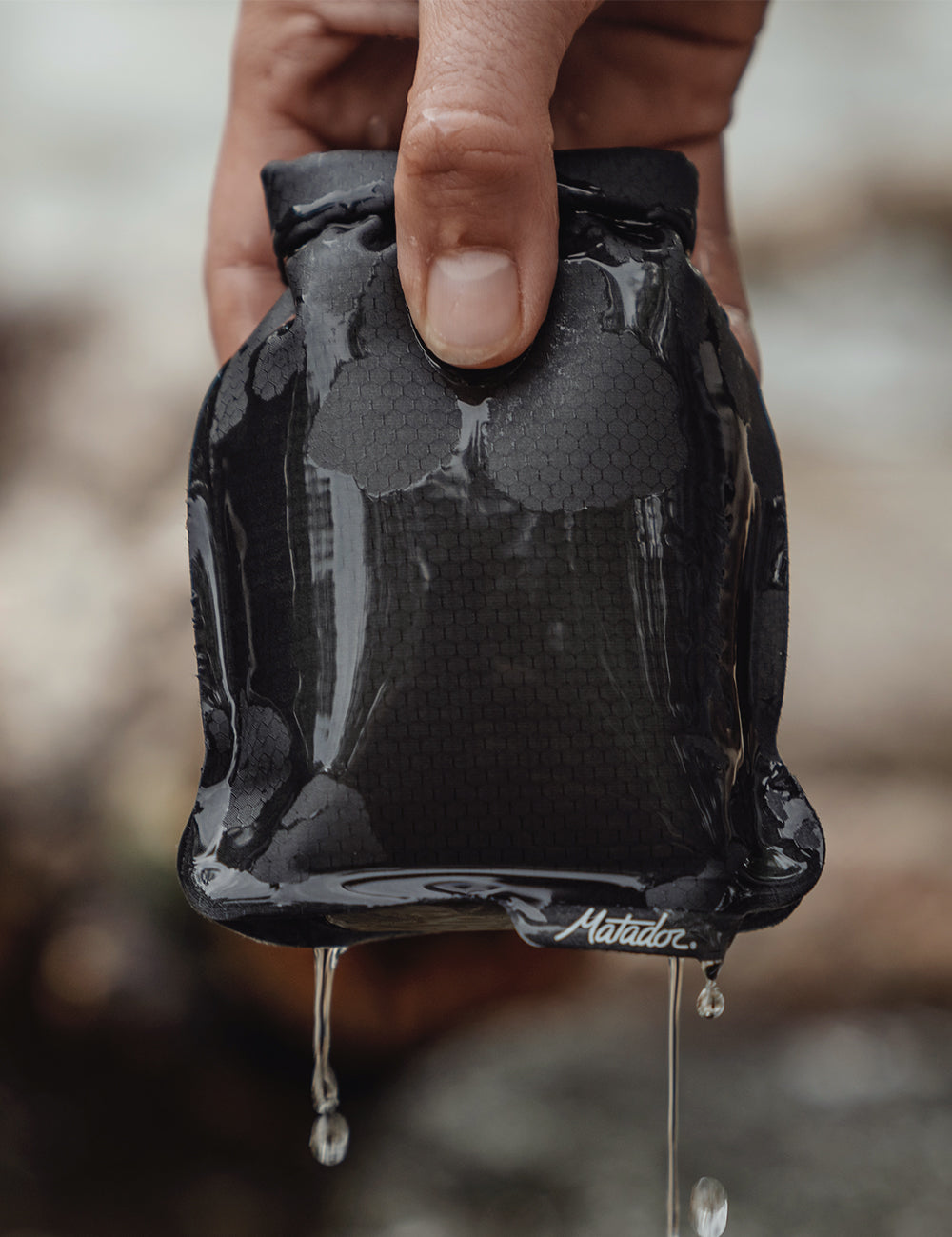 soap bar case being held with water dripping off