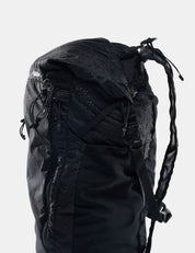 Black backpack with visible brand logo on a light gray background