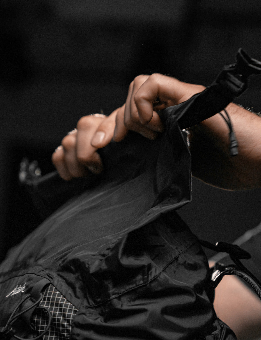 hands rolling down roll top closure