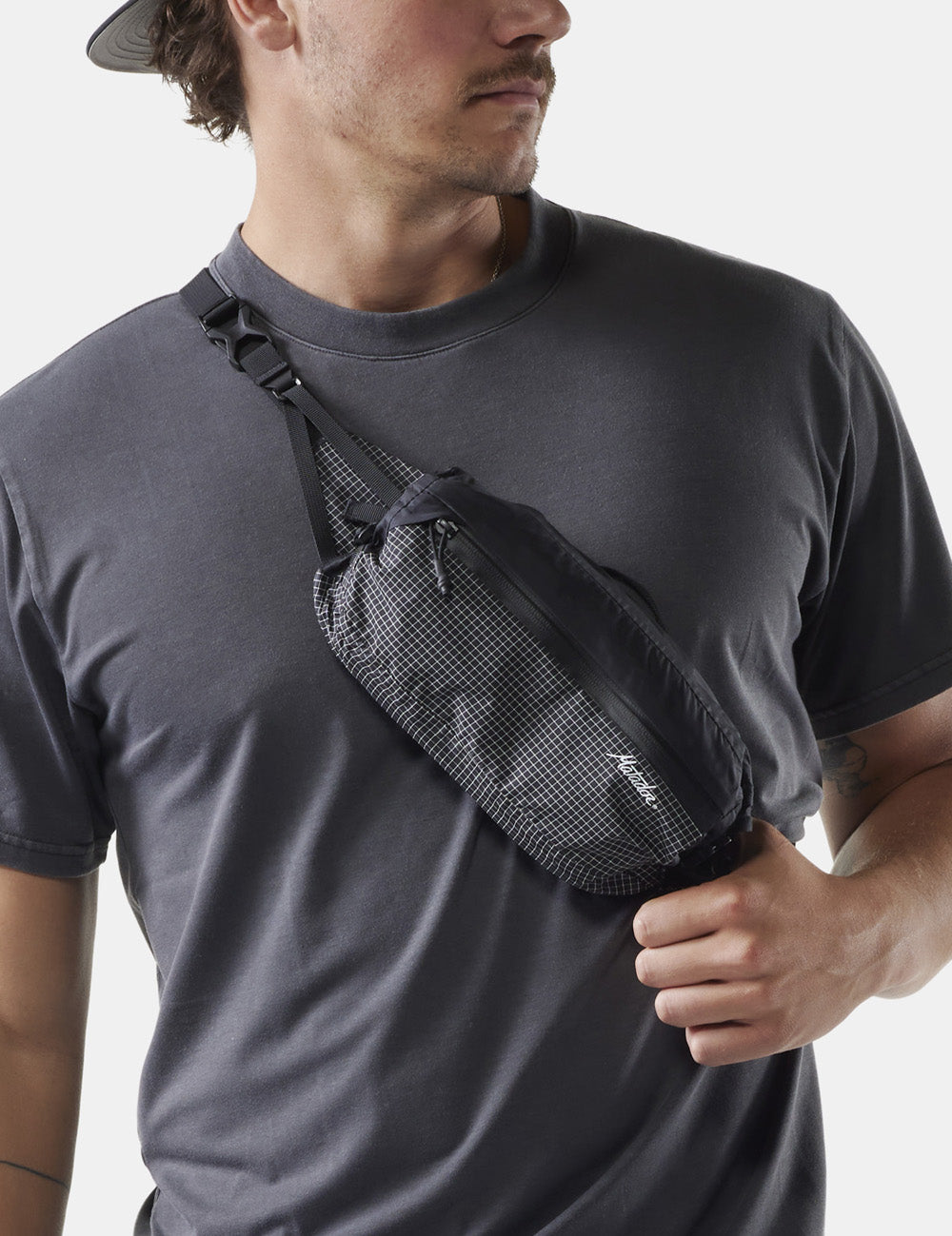 man wearing sling across the front of his chest