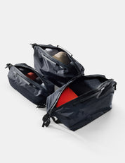 Black travel bag with red interior on a white background