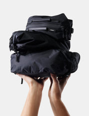 3 black gear cubes being held up on white background