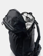 Black backpack with open front compartment on a white background