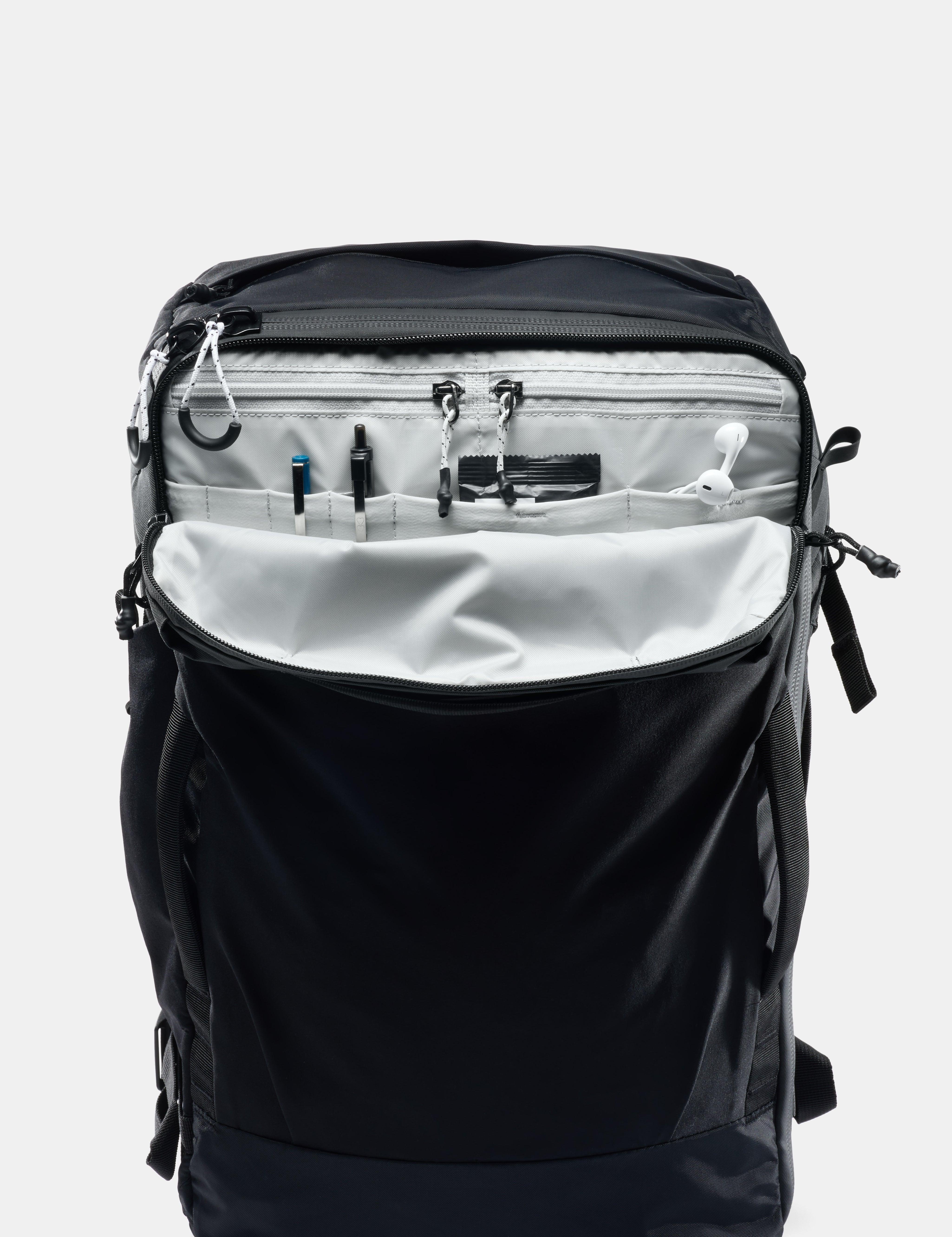 Black backpack with open front compartment on a white background