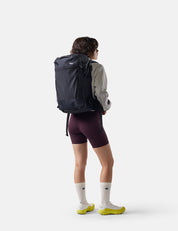 Person wearing a black backpack on a white background
