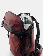 Red backpack with open compartment on a white background