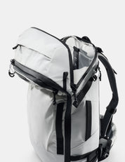 White backpack with black straps on a white background