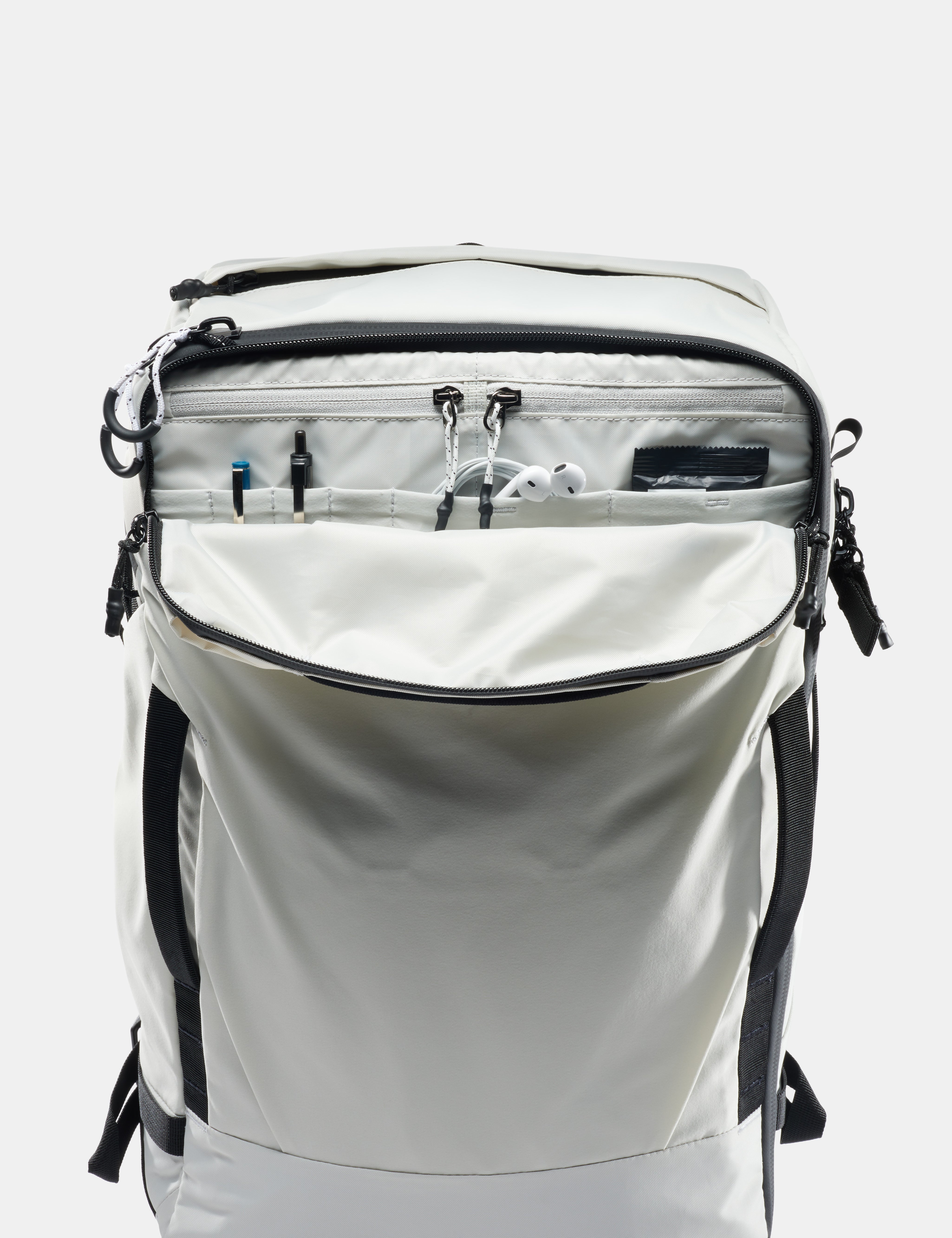 White backpack with black zippers and straps on a white background