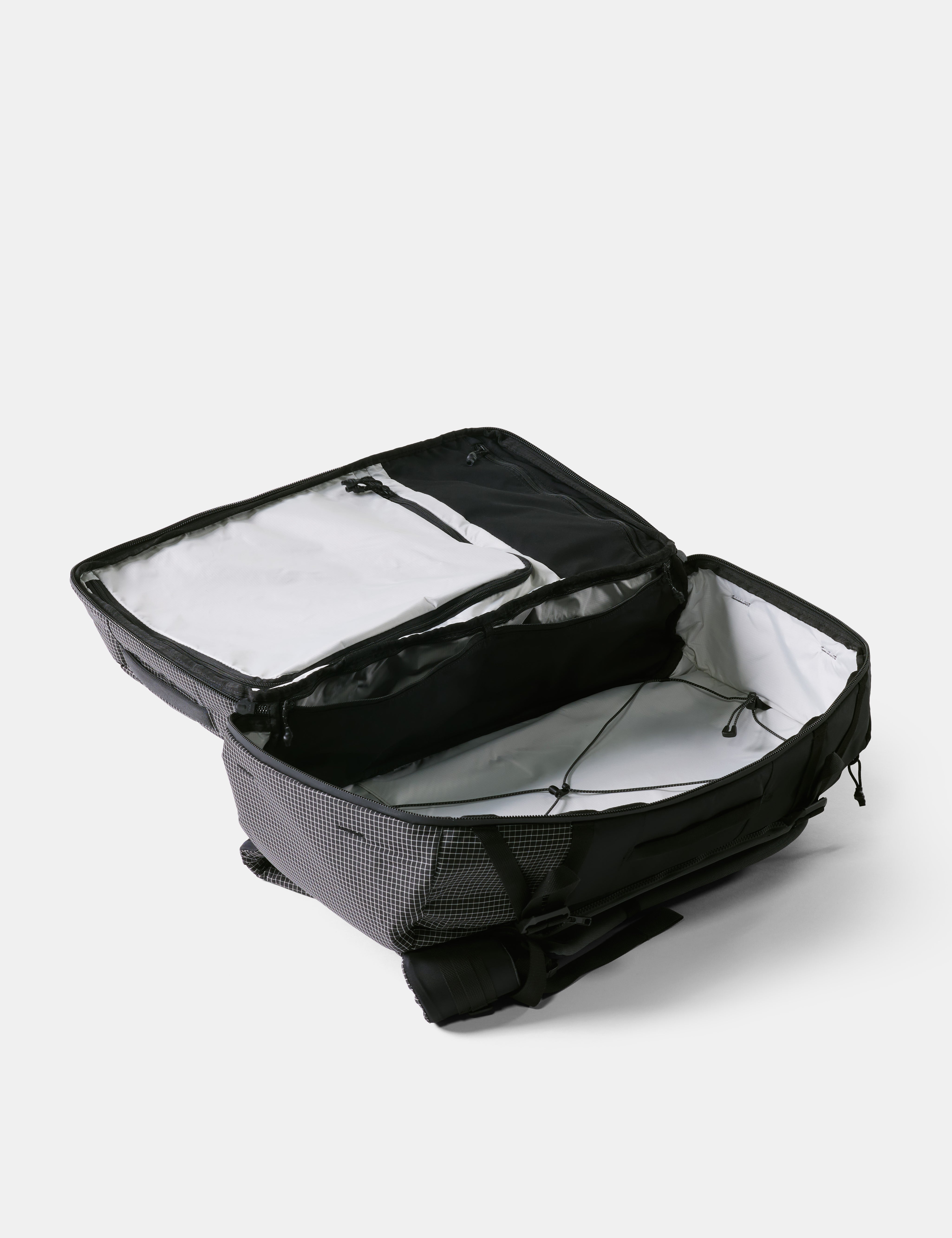 Black backpack with open compartment on a white background