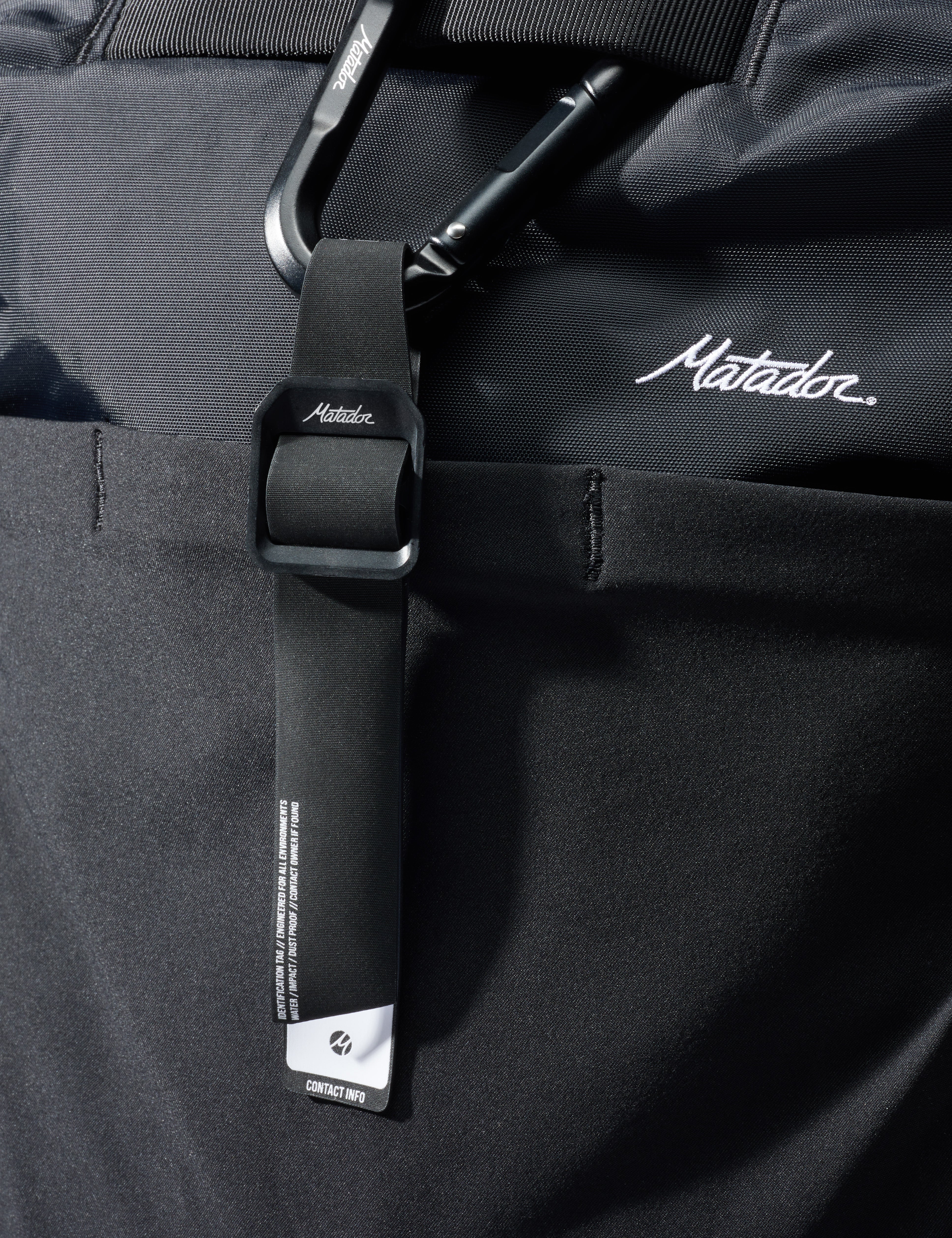 Close-up of a black bag with a strap featuring the Matador logo.