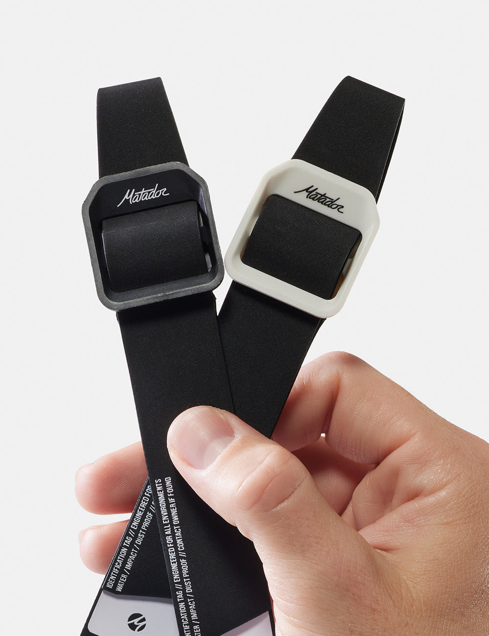 hand holding 2 gear tags