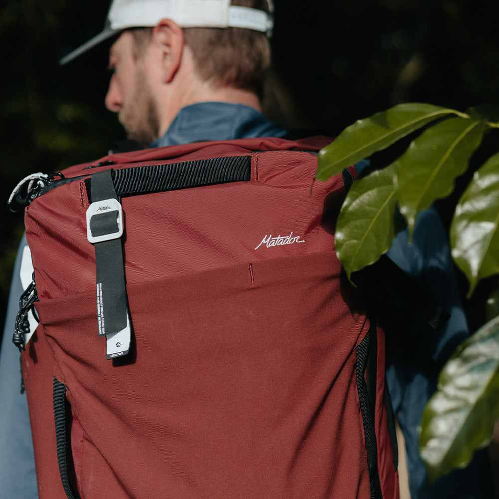 man with garnet bag and gear tag
