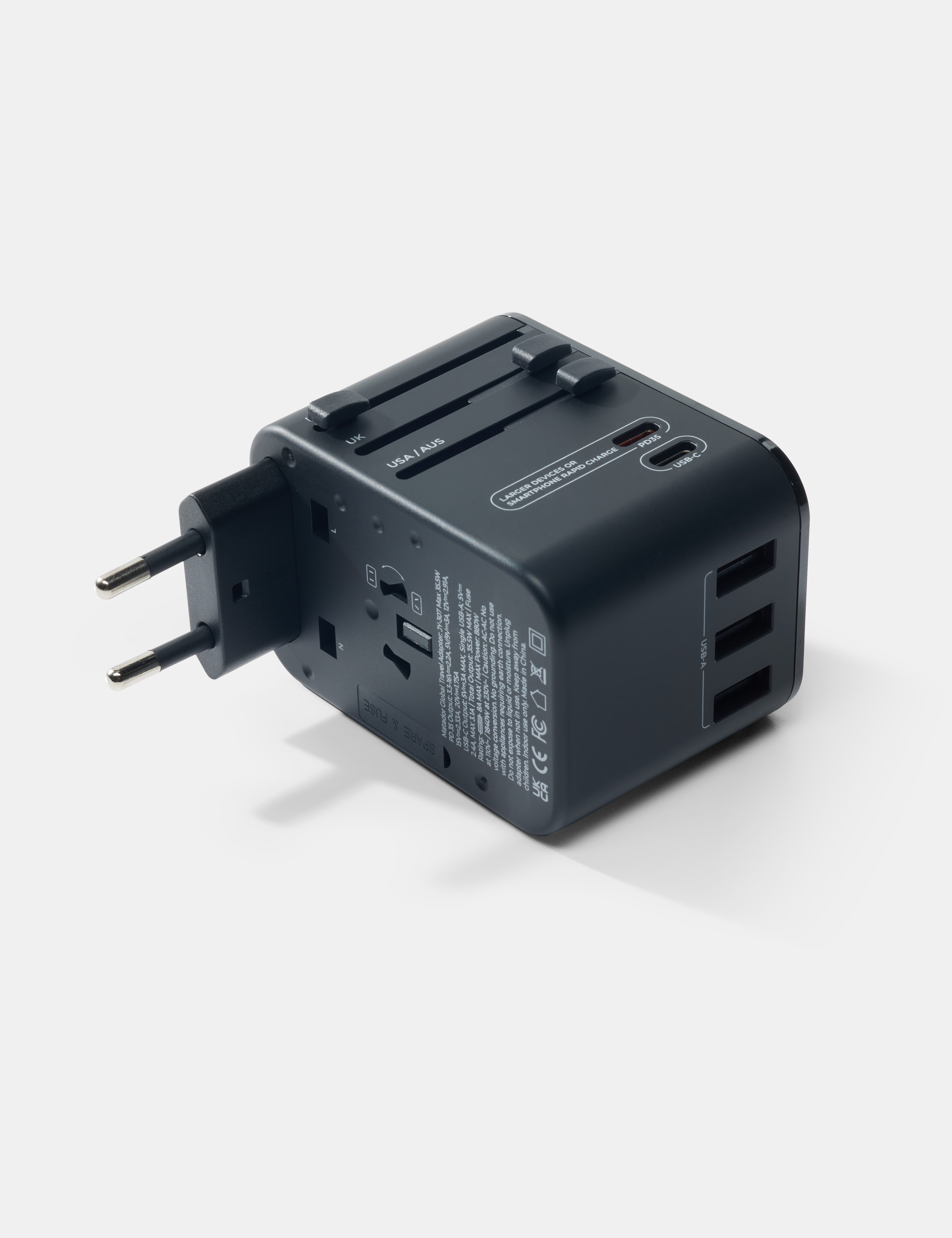 Black travel adapter on a white background