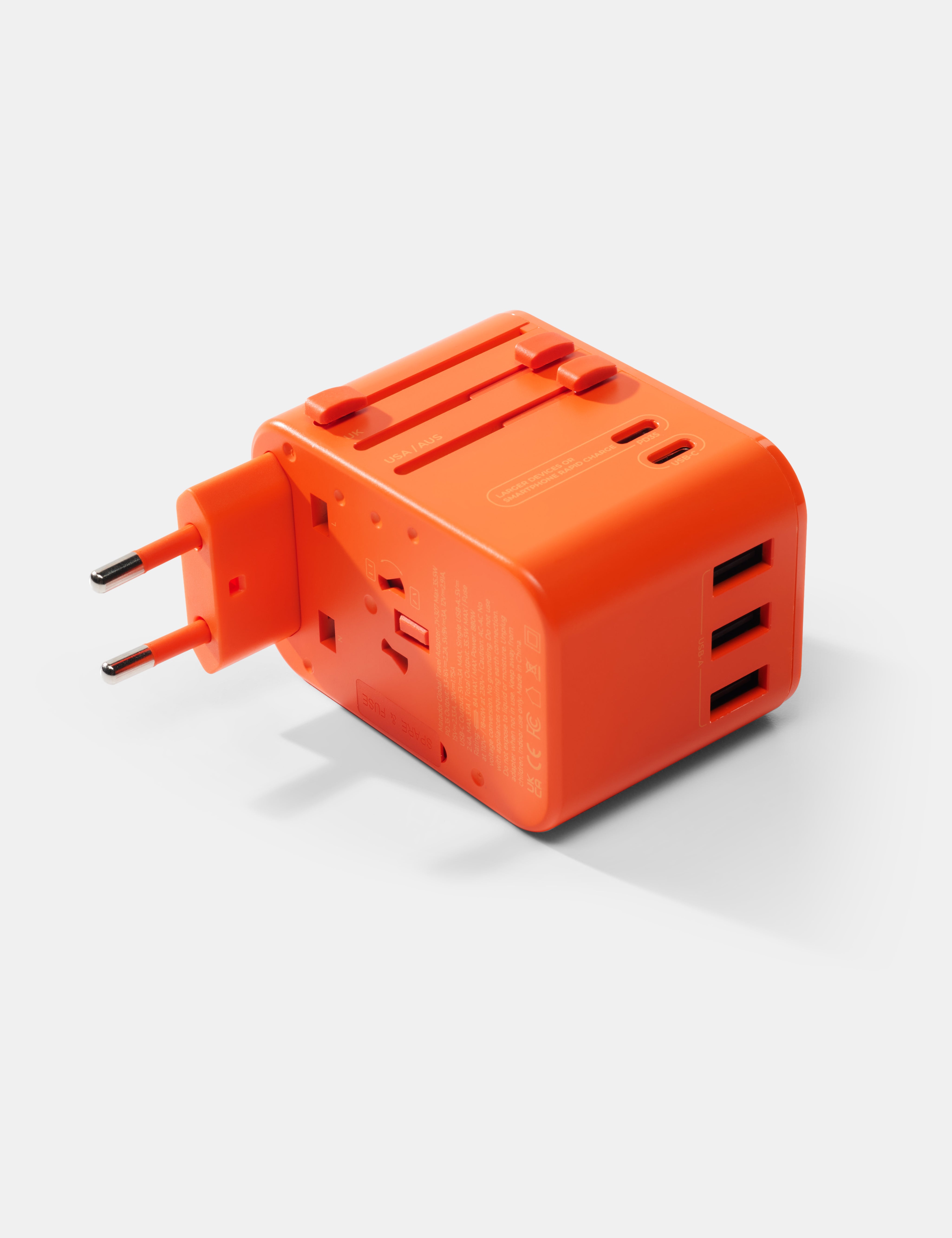 Orange travel adapter with multiple ports on a white background