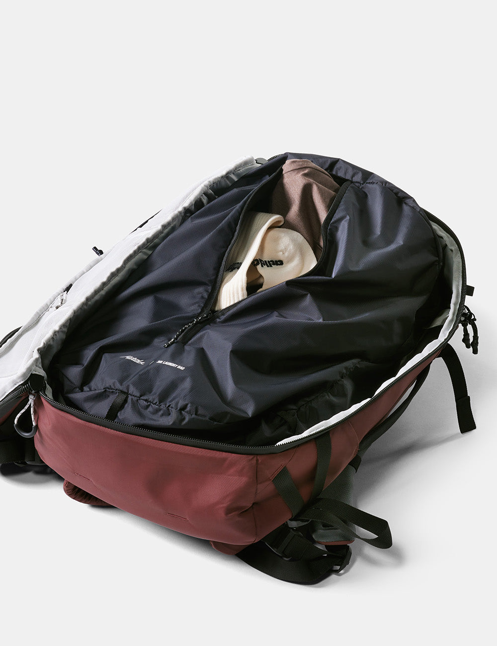 laundry bag with dirty clothing sitting in clamshell opening of bag