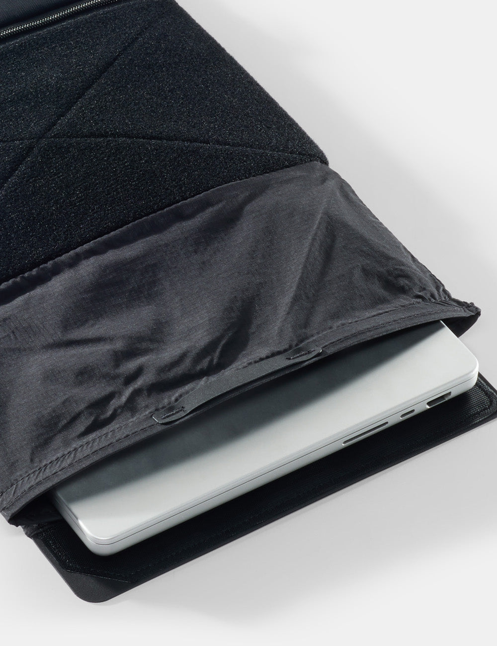 laptop peeking out of baselayer