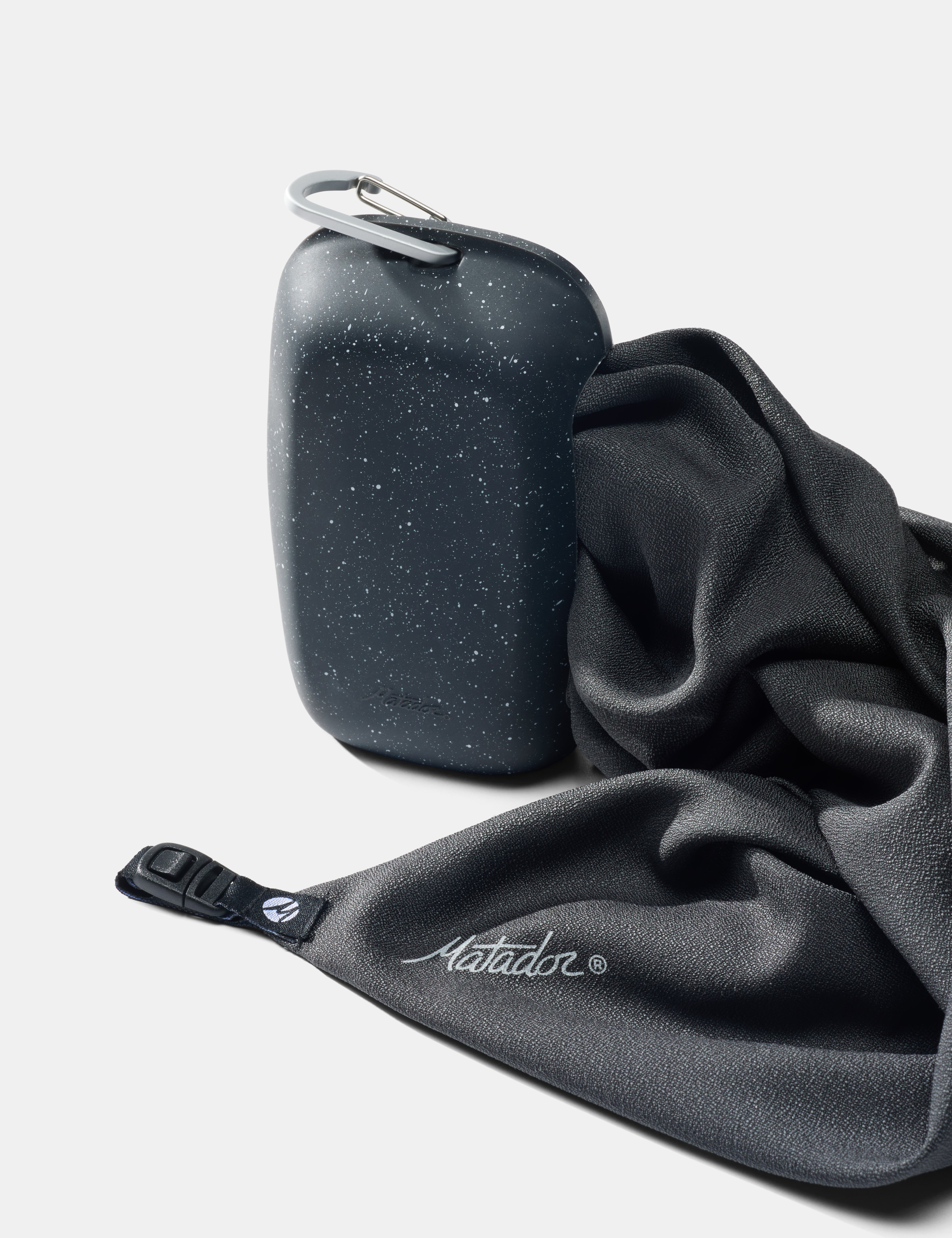 Nanodry towel being pulled out of silicone case on white background