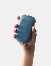 Hand holding slate nanodry case against a white background