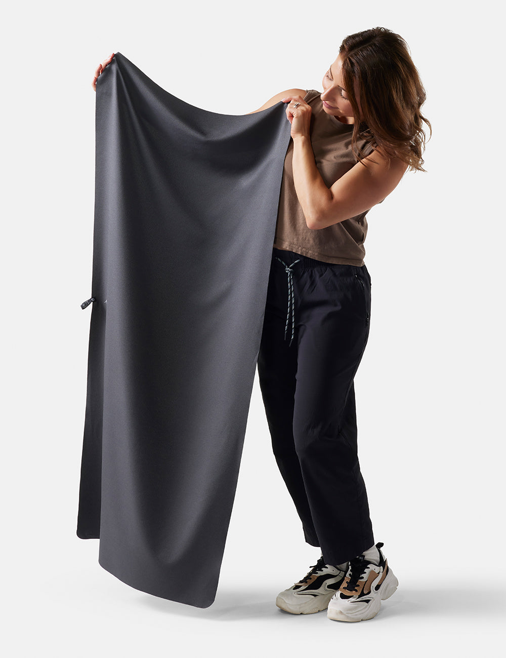 Woman on white background, holding charcoal towel