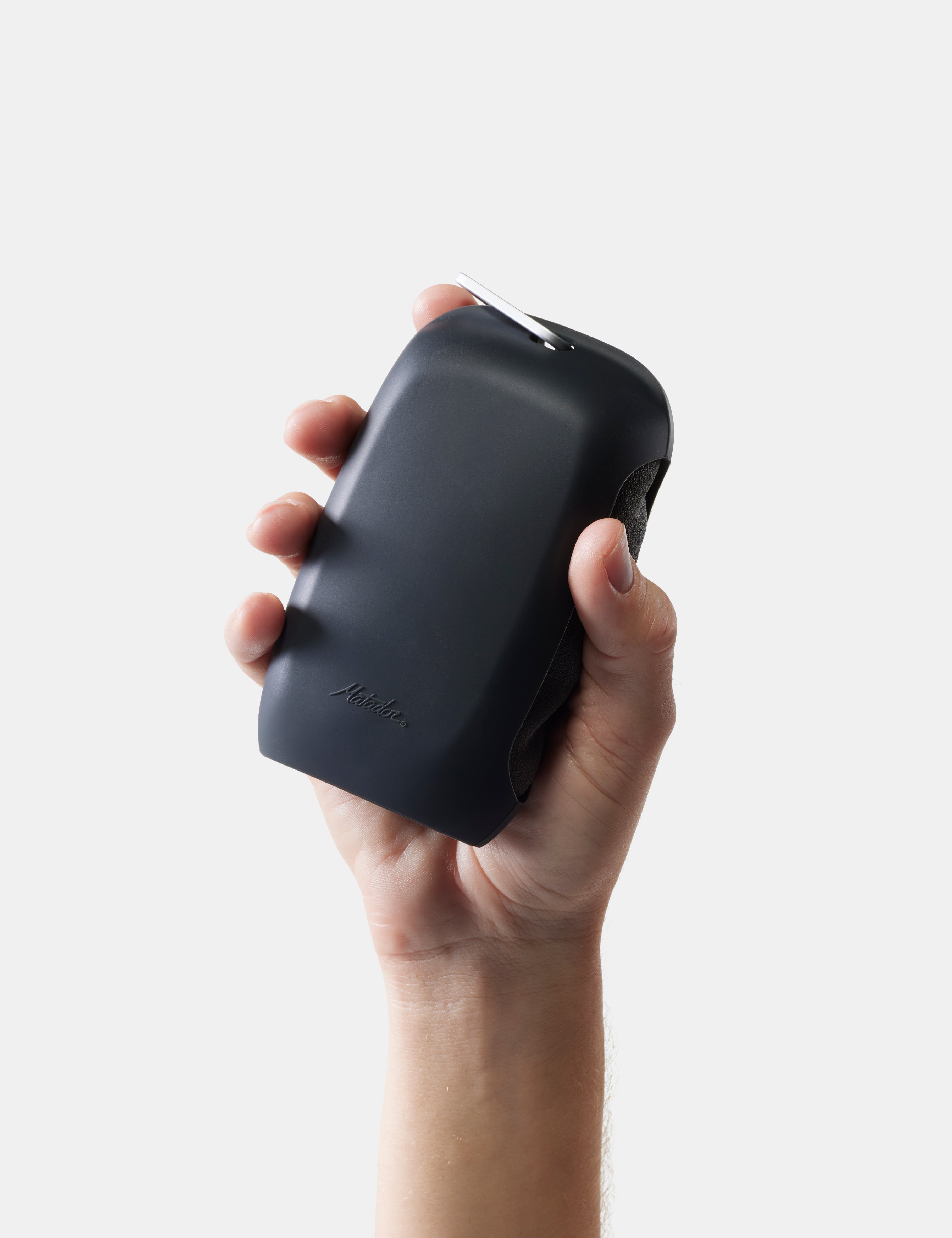 Hand holding a gray towel case against a light gray background