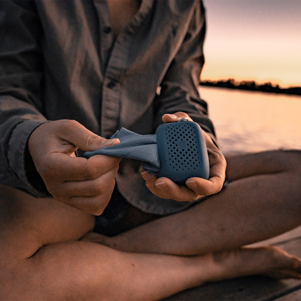 hands pulling blue towel out of small case