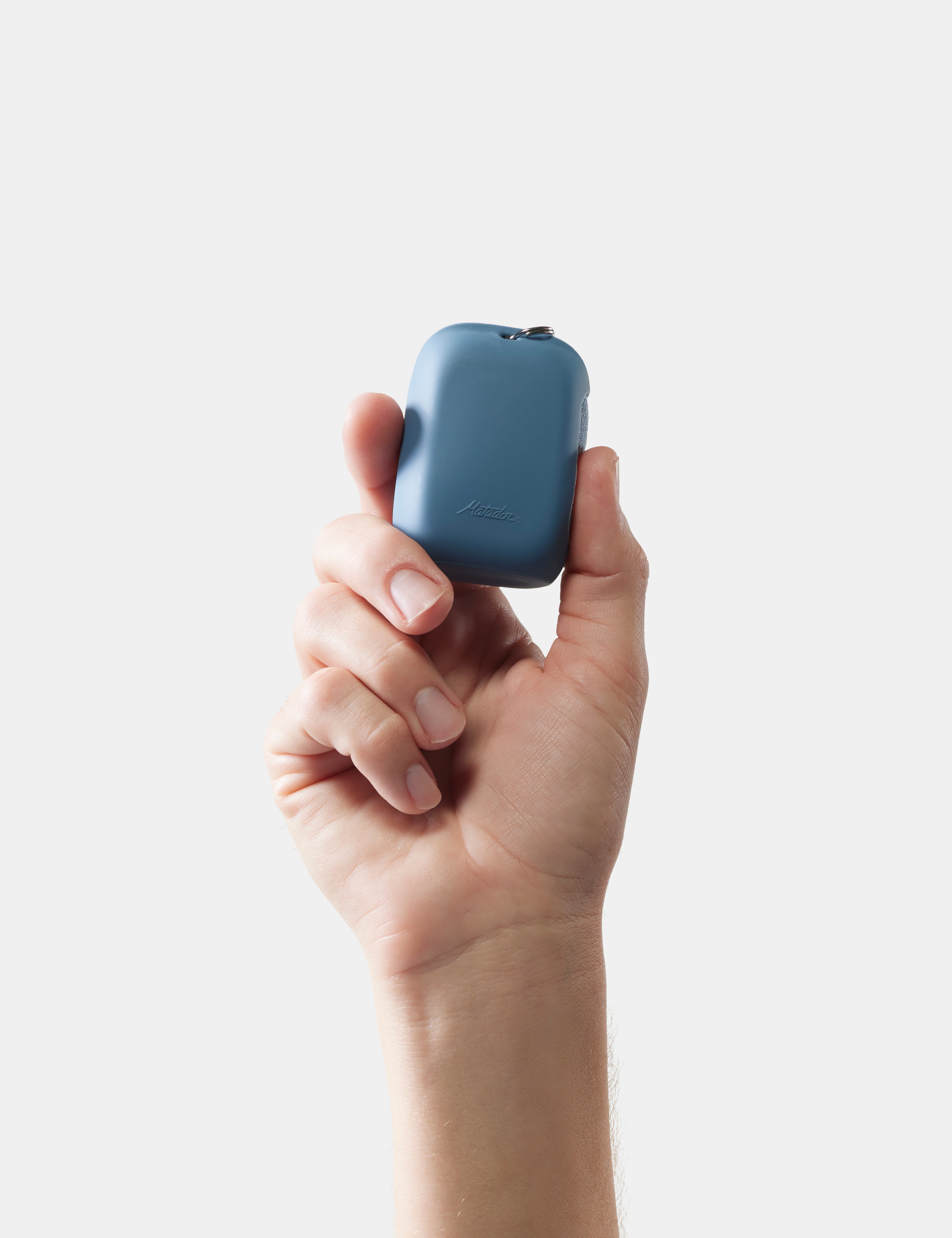 Hand holding slate nanodry case against a white background