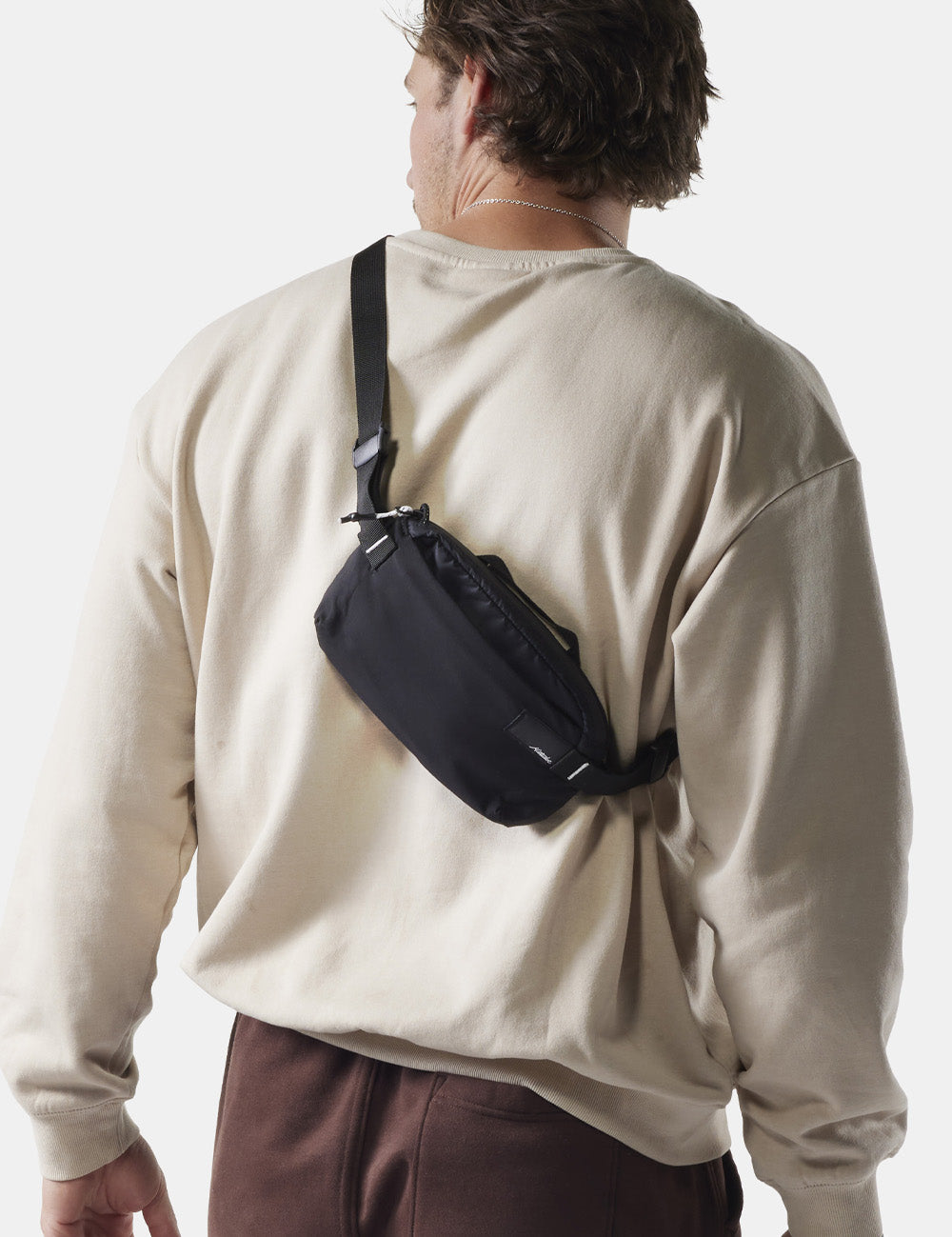 man wearing black sling across his back