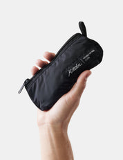 Hand holding a black pouch with 'Matador' branding on a light background