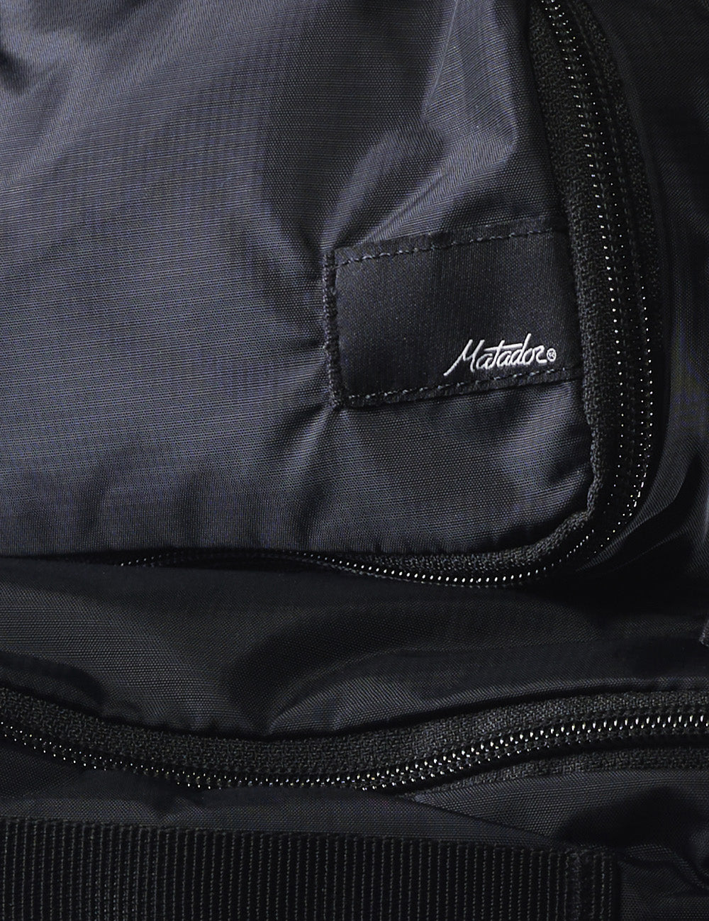 detail shot of packing cube material and matador logo patch