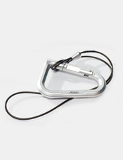 Silver carabiner with a black cord on a white background