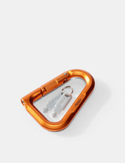 Orange carabiner with a key on a white background