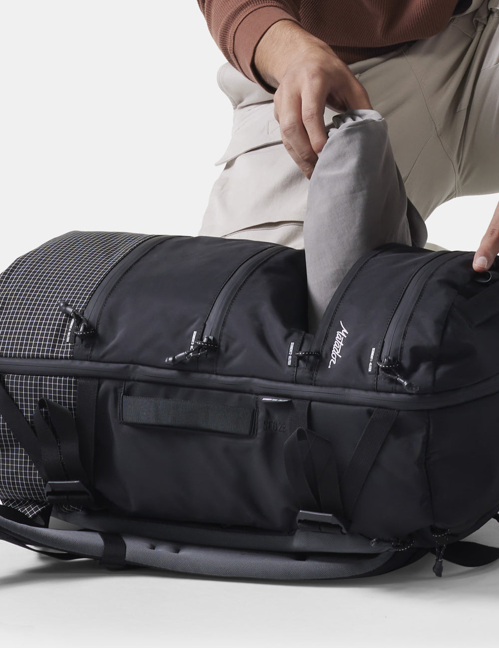 hands pulling clothing out of a segment of the SEG28