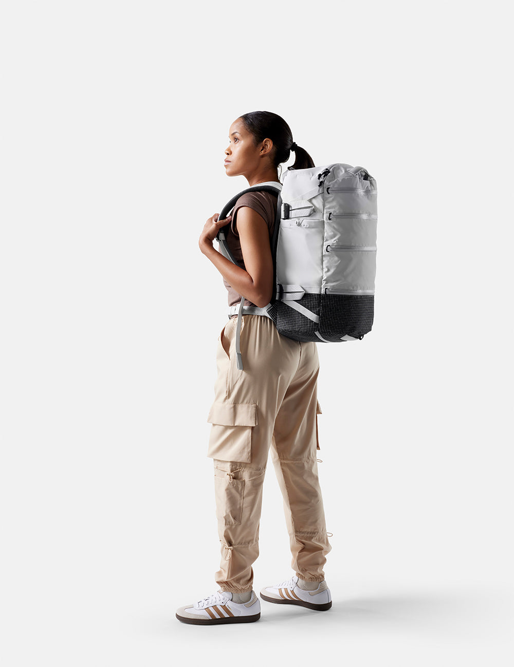 Person wearing a large backpack on a white background
