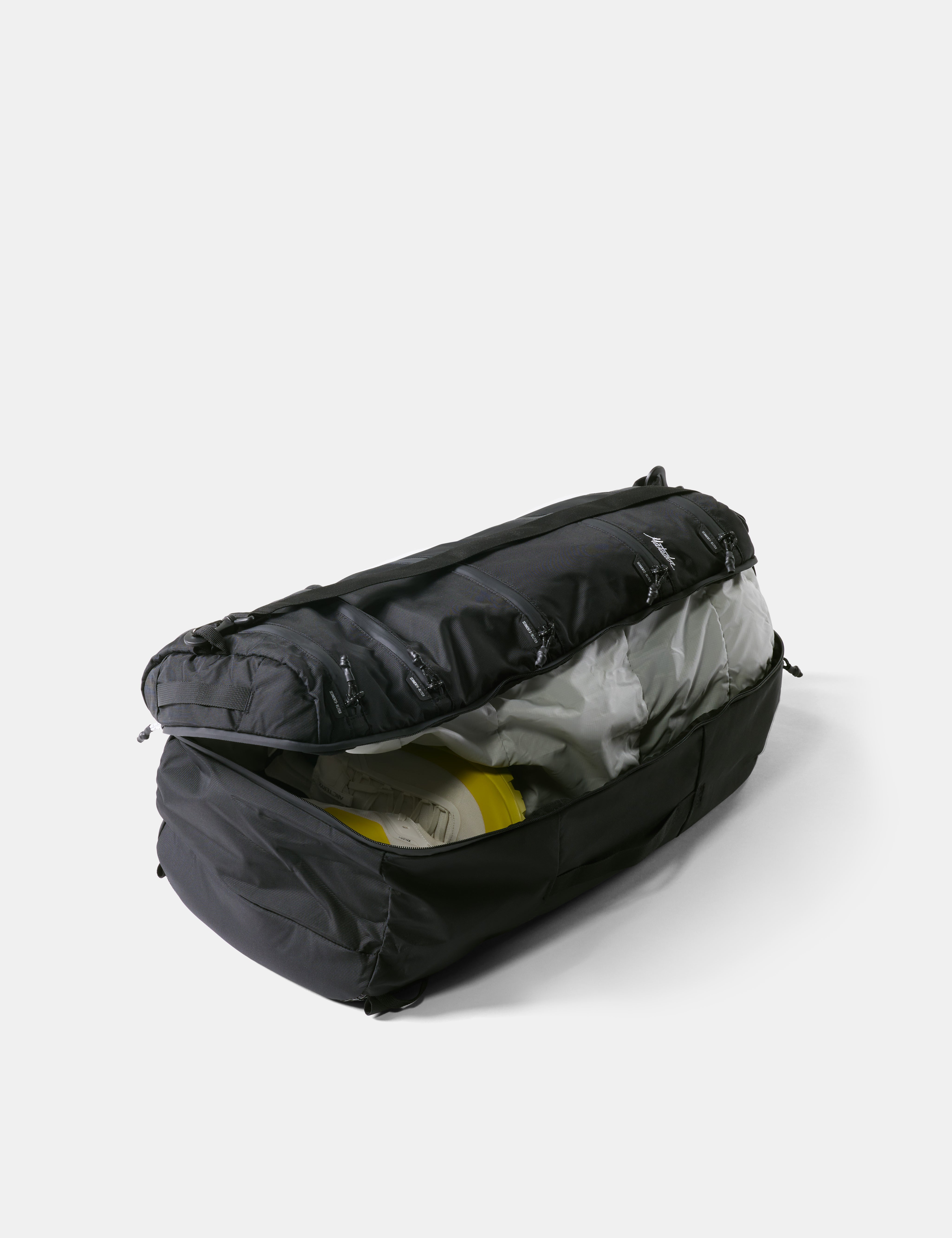 Black duffel bag with open lid on a white background