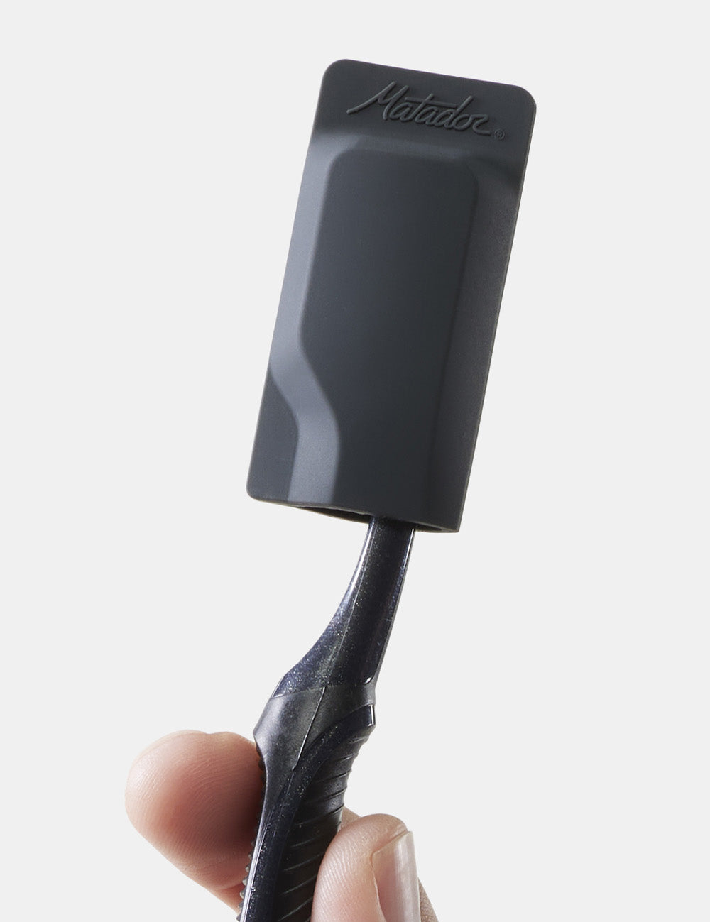 hand holding black toothbrush cap on black toothbrush